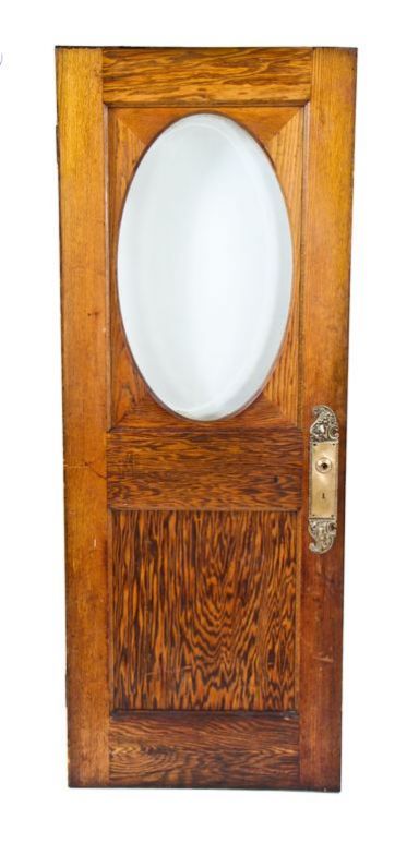 original american victorian era residential exterior oak wood door with oval-shaped beveled plate glass