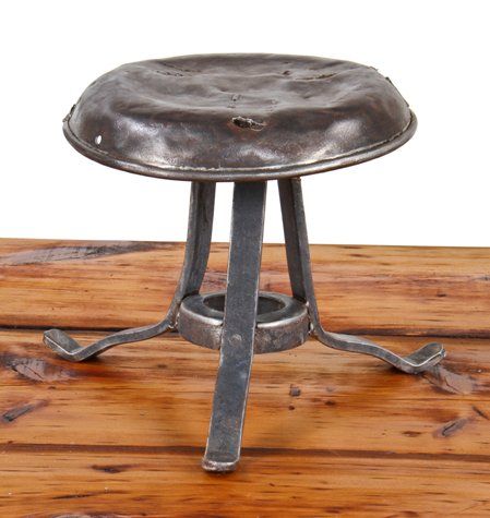 original and intact early 20th century vintage industrial heavy gauge steel three-legged riveted joint milking stool 