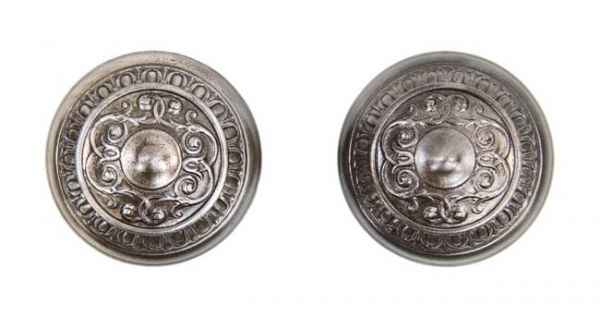 pair of matching early 20th century ornamental wrought steel passage size "mantua" pattern doorknobs with foliated scrollwork and egg & dart border