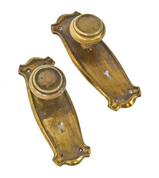 single set of original c. 1920's american craftsman style ornamental stamped yellow brass doorknobs with matching backplates 