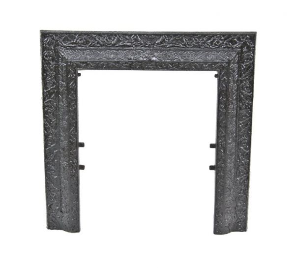largely intact original C. late 19th century black enameled decorative cast iron fireplace summer cover surround with richly ornate allover foliage 