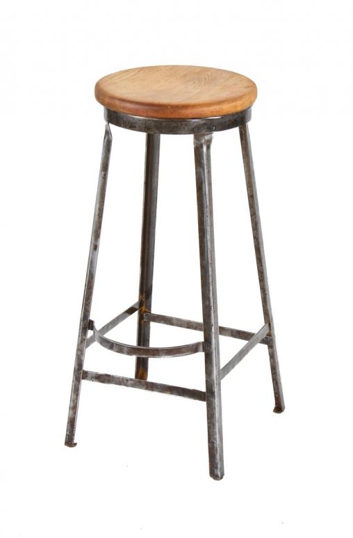four-legged brushed metal american industrial angled "ot-steel" factory workshop stool with maple wood seat and protruding footrest
