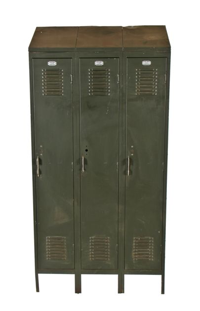 american c. late 1940's industrial baked army green enameled angled top three-unit freestanding locker with louvered doors