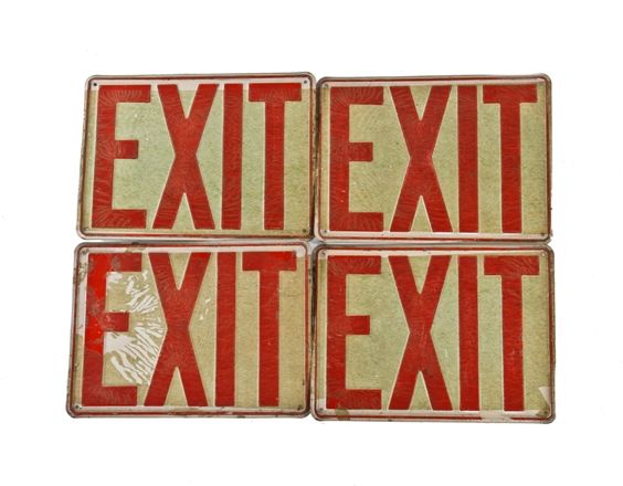 group of four matching american depression era "new old stock" embossed stamped tin exit signs with original wrappping