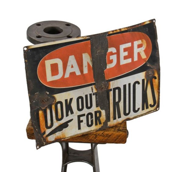 weathered and worn c. 1930's american industrial exterior factory building warning or cautionary "look out for trucks" porcelain enameled sign
