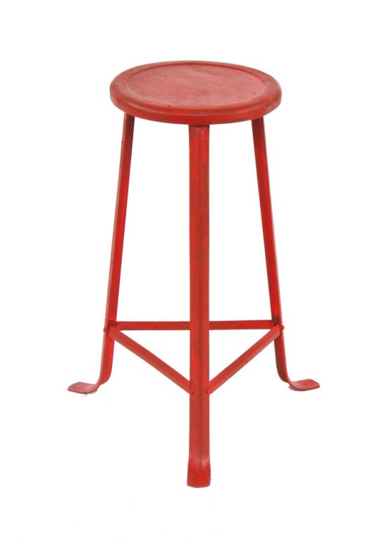 intact and original antique american industrial red painted riveted joint angled three-legged stationary stool with pressed and folded metal seat