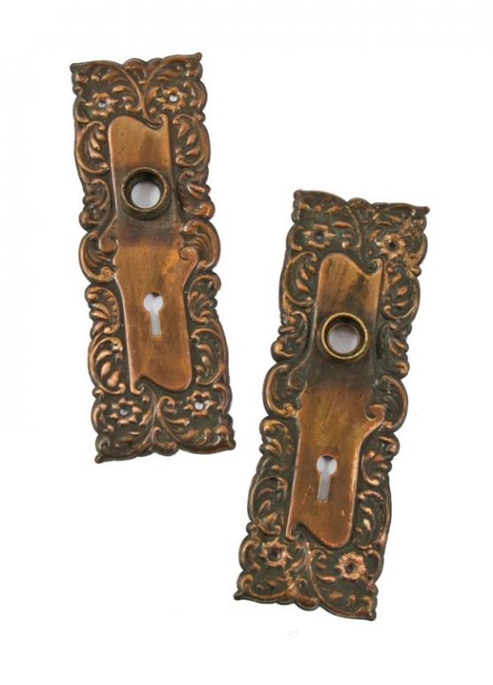 original early 20th century ornamental stamped bronze metal "eulalia" pattern interior residential doorknob backplates