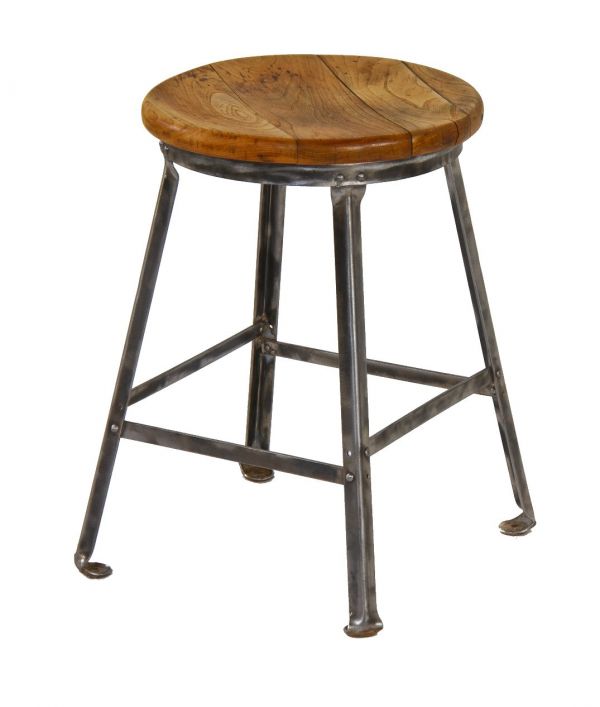original well-built c. 1940's four-legged angled iron low lying stool with brushed metal base and refinished maple wood seat