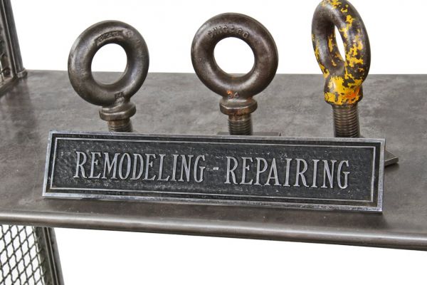 heavy cast bronze c. 1920's self-supporting cast bronze "remodeling-repairing" advertising shop counter sign with black enameled inlay