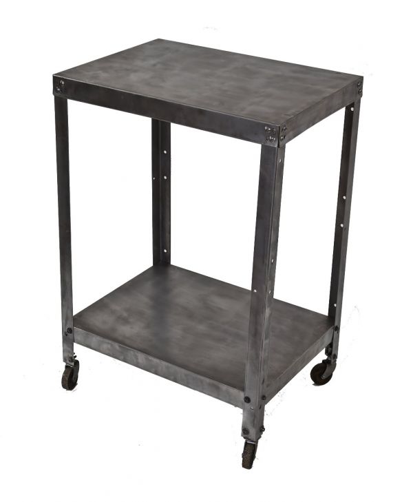 lightweight c 1940's refinished cold-rolled angled steel four-legged two tier mobile factory cart with uniform brushed metal finish and swivel casters