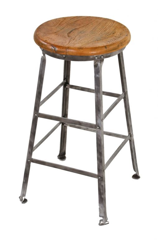 refinished heavy gauge angled steel stationary factory machine shop stool with solid maple wood seat and riveted joint stretchers