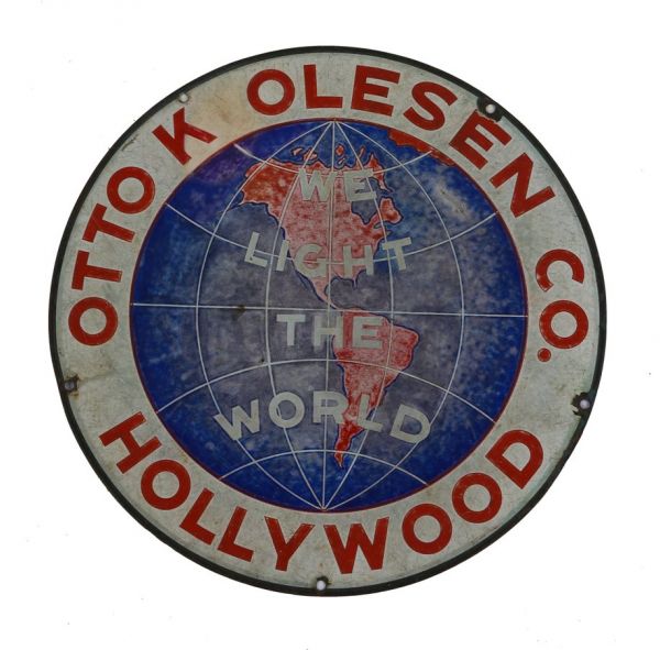 rare single-sided c. 1930's "we light the world" single-sided die cut steel porcelain enameled hollywood studio stage light advertising sign