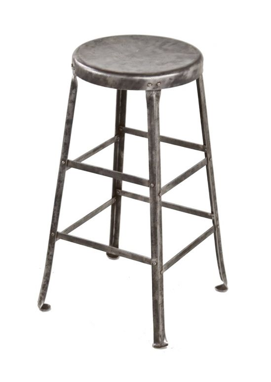 original c. 1930's american industrial riveted joint four-legged angled steel factory machinist stool with brushed metal finish 