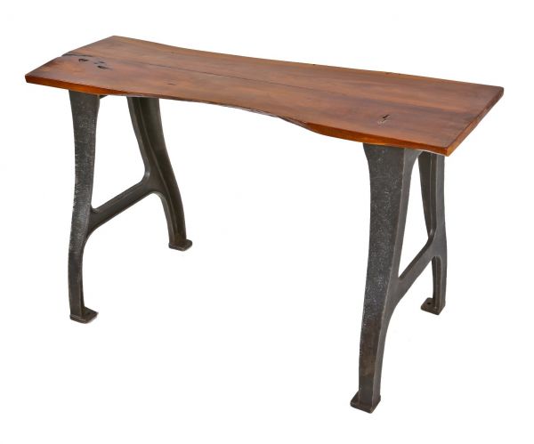 well-proportioned american industrial repurposed stationary side table or consle featuring a solid cherry wood slab top and cast iron factory machine bases