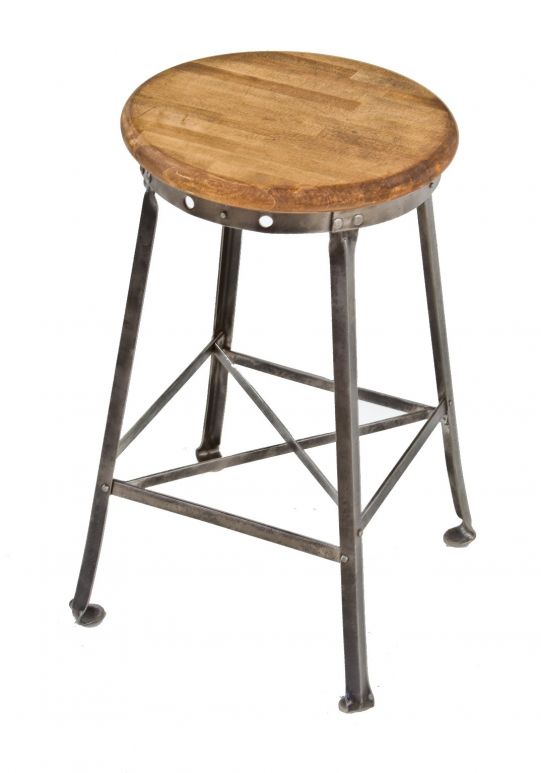 original american c. 1930's industrial four-legged angled steel low-lying stationary stool with lightly stained solid maple wood seat