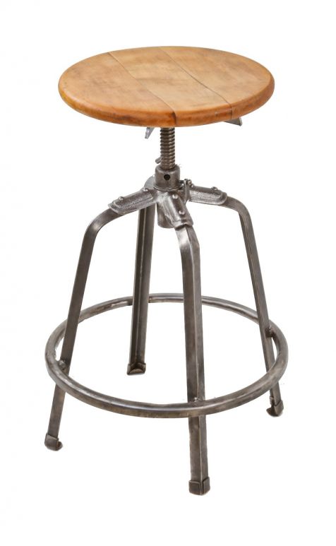fully adjustable four-legged stationary riveted and welded joint stool with  a brushed and sanded bare metal finish and original solid maple wood 