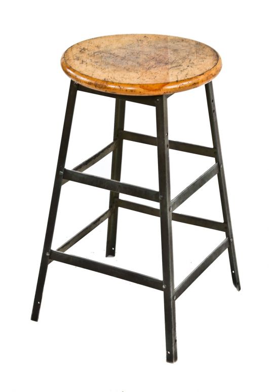 single four-legged vintage american industrial freestanding backless riveted joint angled iron pollard stool with original weathered solid maple wood circular-shaped seat