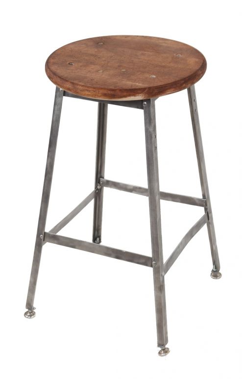refinished c. 1950's american industrial four-legged riveted joint angled iron stationary stool with adjustable threaded level mounts and original solid maple wood seat
