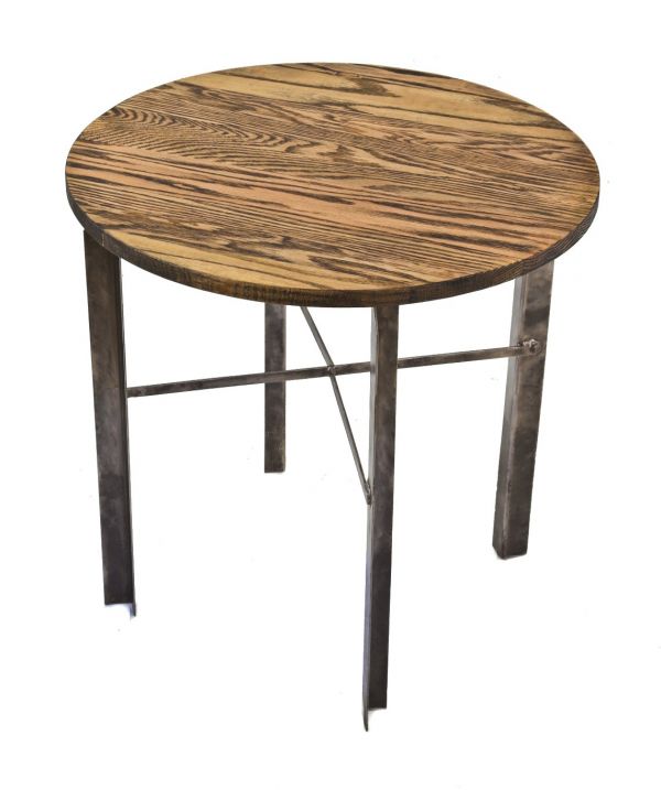 american industrial vintage four-legged angled steel low-lying occasional or side table with a newly added distressed oak wood circular-shaped tabletop