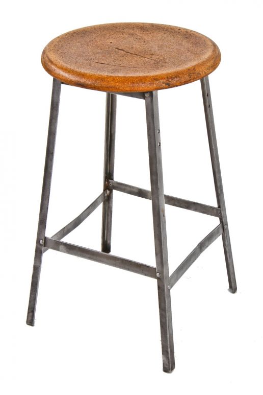 american c. early 1950's industrial four-legged riveted joint angled steel factory machine shop stool with intact stretchers and original circular-shaped seat