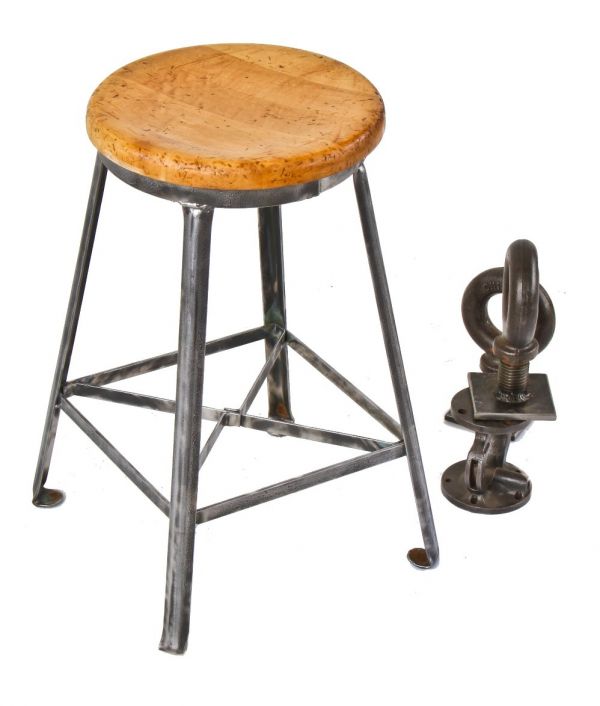 sturdy late 1920's low-lying american industrial four-legged angled steel stool with riveted joint cross-bracing and intact solid maple wood stool seat