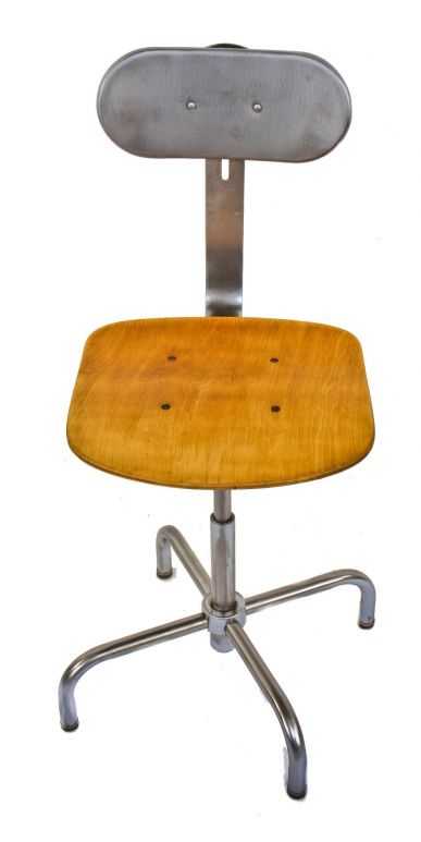 one of two matching original fully adjustable refinished vintage american industrial bent tubular steel stationary stool with maple wood saddle seat