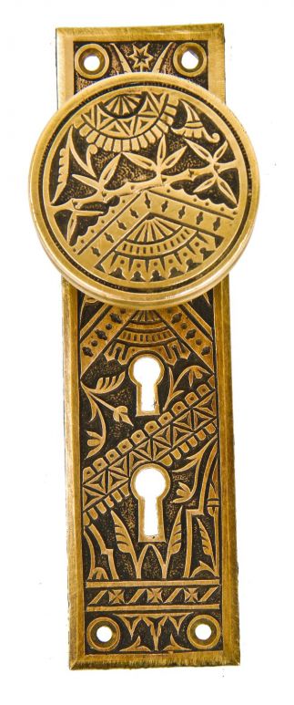 all original 19th century exterior residential eastlake style ornamental cast brass "oriental" pattern backplate with matching "bamboo" pattern oversized drum-shaped doorknob