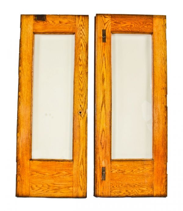 pair of original c. 1897 exterior chicago two-flat residential two-part or double door assembly comprised of varnished oak wood with beveled edge plate glass panes