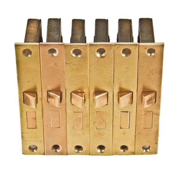 group of six matching fully functional c. 1897 interior residential passage door mortise locks with refinished unornamented cast brass faceplates 