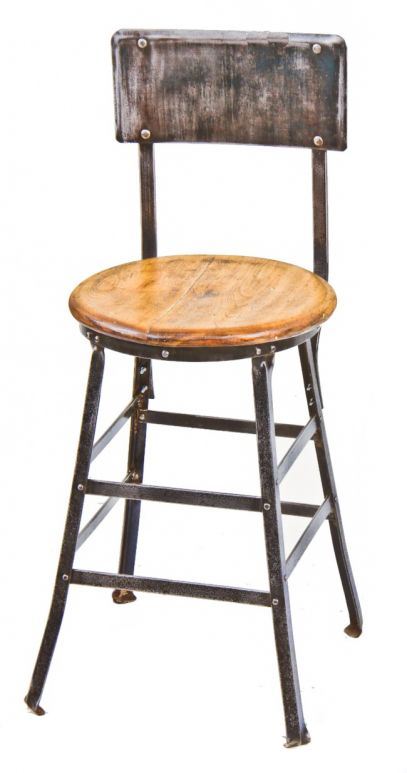 late 1920's original and completely refurbished freestanding four-legged riveted joint steel american industrial stool with intact varnished maple wood circular seat