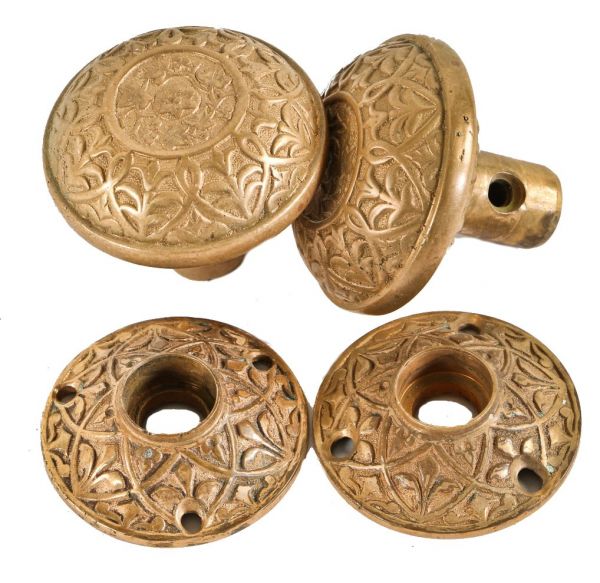 complete set of original 19th century ornamented cast bronze metal banded rim residential doorknob with matching decorative rosettes