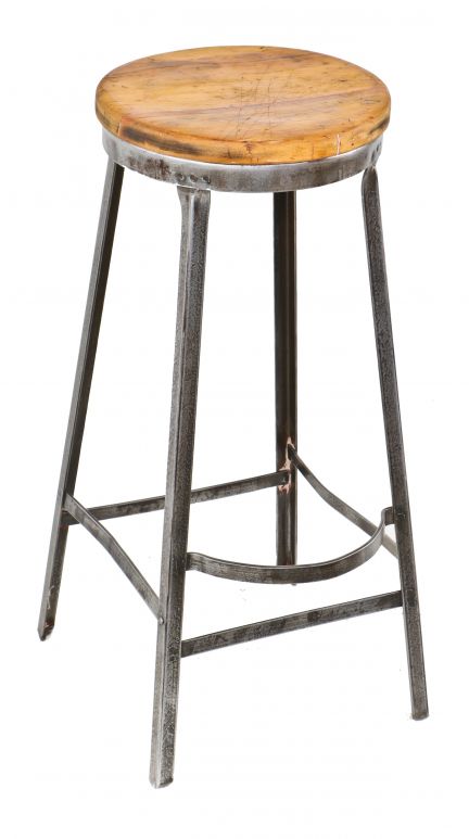 original c. 1930's american antique industrial four-legged angled steel factory machine shop stationary stool with brushed metal finish and protruding footrest 
