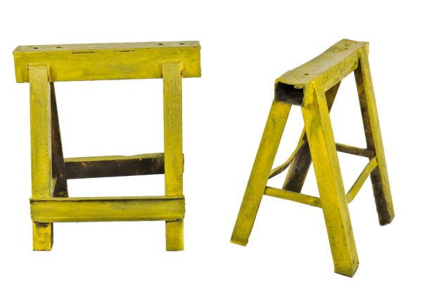 set of nearly identical remarkably heavy yellow-painted depression era american industrial antique welded joint chicago foundry sawhorses  
