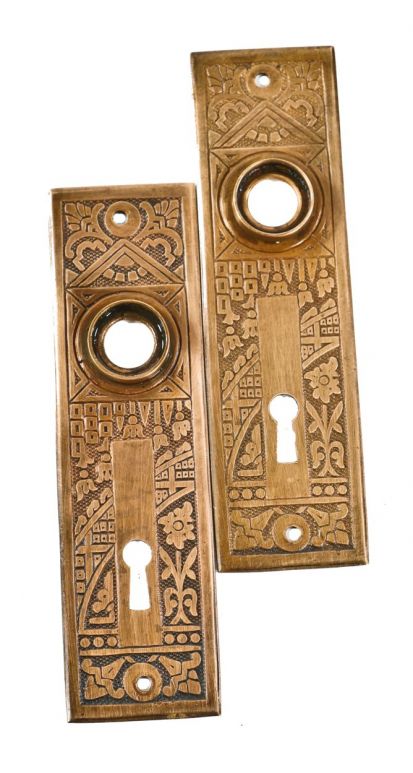 matching set of 19th century wrought ornamental brass "ceylon" pattern interior residential doorknob backplates with nicely aged surface patina 