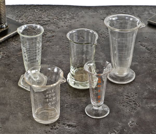 group of original vintage american industrial drugstore or apothecary etched  and enameled clear glass whitall and tatum measures