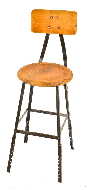 c. 1950's single adjustable height four-legged riveted joint angled iron pollard stool with slightly contoured maple wood backrest and brushed metal finish 