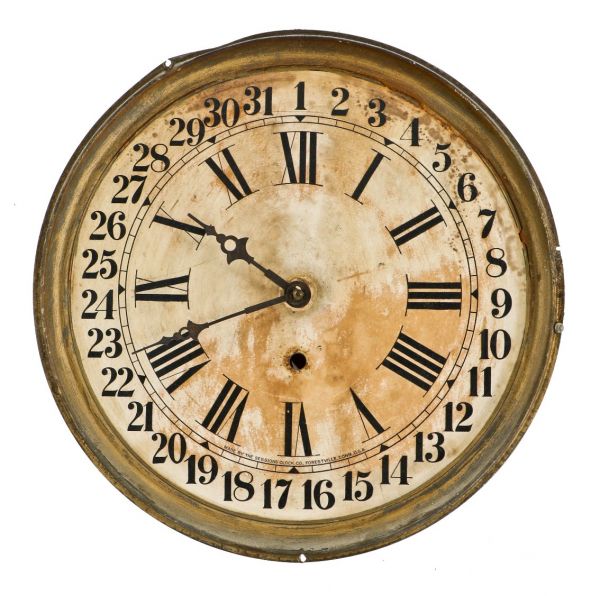 original nicely weathered depression era lightweight enameled tin numbered clock face with attached gear assemblage and decorative hour and minute hands.  
