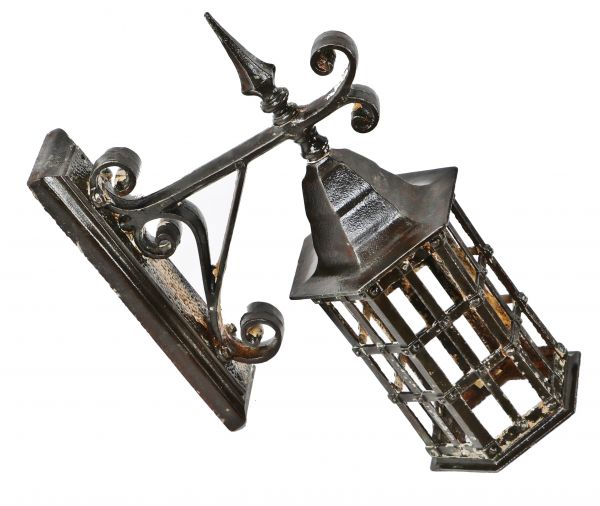 remarkable turn of century oversized north side chicago exterior church building ornamental wrought and cast iron wall sconce with a mostly uniform brushed metal finish 