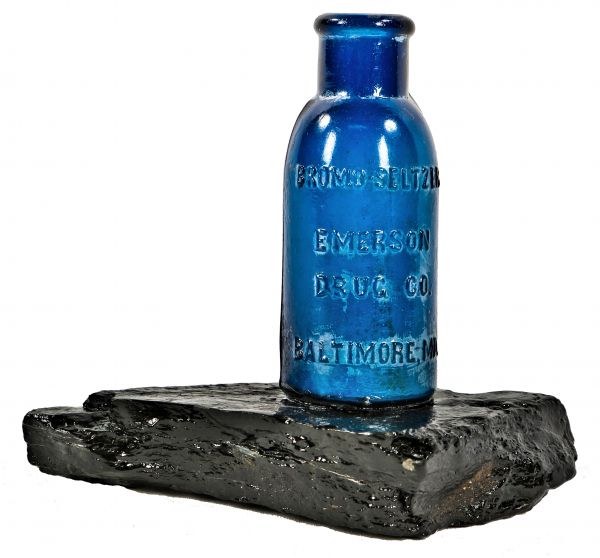repurposed nineteenth century industrial paperweight comprised of a cobalt 1890's bromo seltzer bottle affixed to a piece of coal