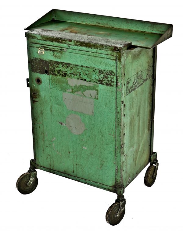 nicely worn, original and intact mid-20th century mobile "factory green" enameled pressed and folded steel tool cart with single oversized cabinet door