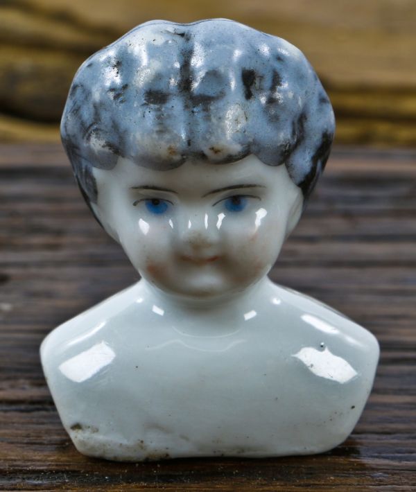 original and antique nineteenth century frozen charlotte or bathing baby  porcelain doll head dug from a chicago area demolition site