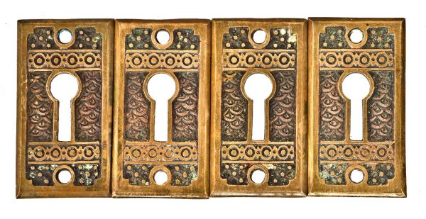 a group of original 1880's antique american ornamental cast brass interior residential "brocade" pattern oversized keyhole escutcheons 