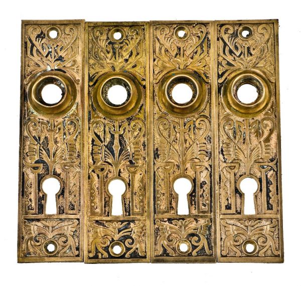 group of four matching all original c. 1880's cast brass interior church building eastlake style doorknob backplates with traces of original black enameled inlay 