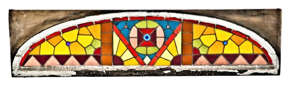 oversized brightly colored antique american salvaged chicago residential stained glass window consisting of simple geometric shapes accentuated with opposed jewels 