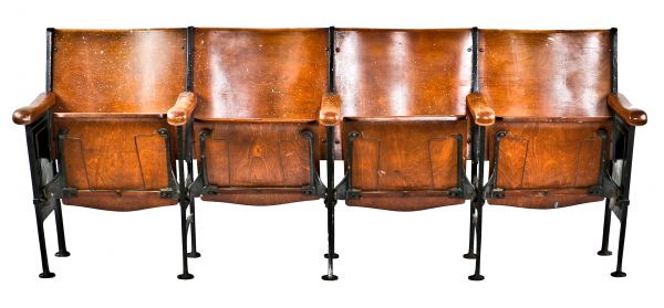 original and intact c. 1920's freestanding robust cast iron and varnished birch wood "theater" style drop-down four-seat chair section with flanking decorative seat ends