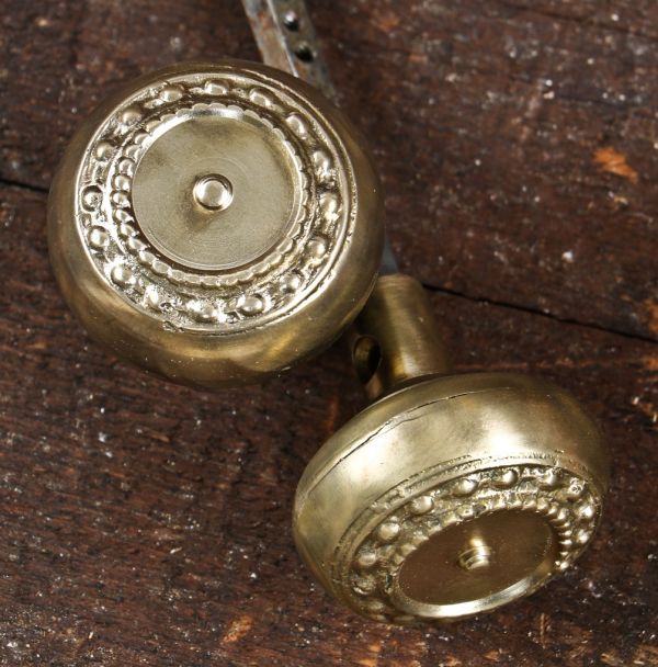 original early 20th century antique american interior residential cast brass "como" pattern banded rim doorknobs salvaged from a chicago residence undergoing demolition