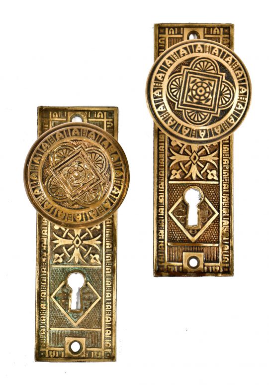 19th century matching eastlake style antique american cast ornamental brass interior residential passage door escutcheons and doorknobs with nicely aged patina 