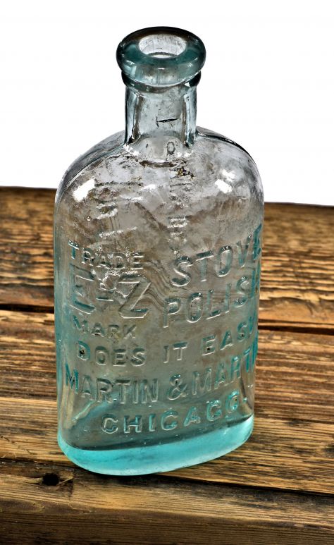 all original and completely intact heavily embossed early 20th century aqua blue glass "e-z polish" bottle fabricated for martin & martin of chicago, il.