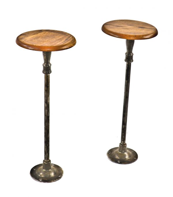 two original freestanding antique american matching drake hotel soda fountain swivel seat stools with intact oak wood seats and brushed cast iron pedestal bases 