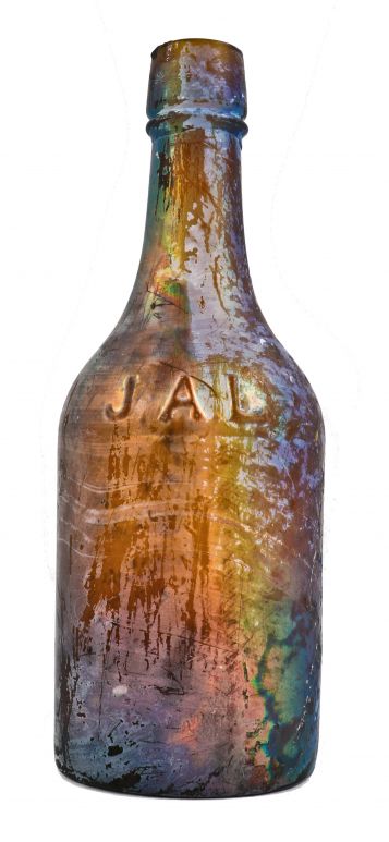 exceptional rare and original antique dug mid-nineteenth century irridized honey amber glass bottle manufactured for chicago bottling giant john lomax